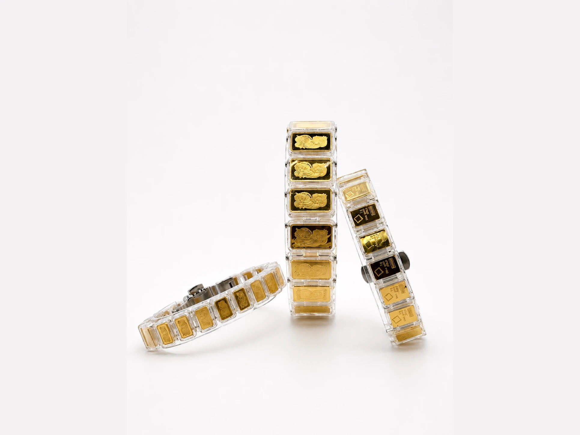 Three bracelets of linked capsules, stacked against a white ground