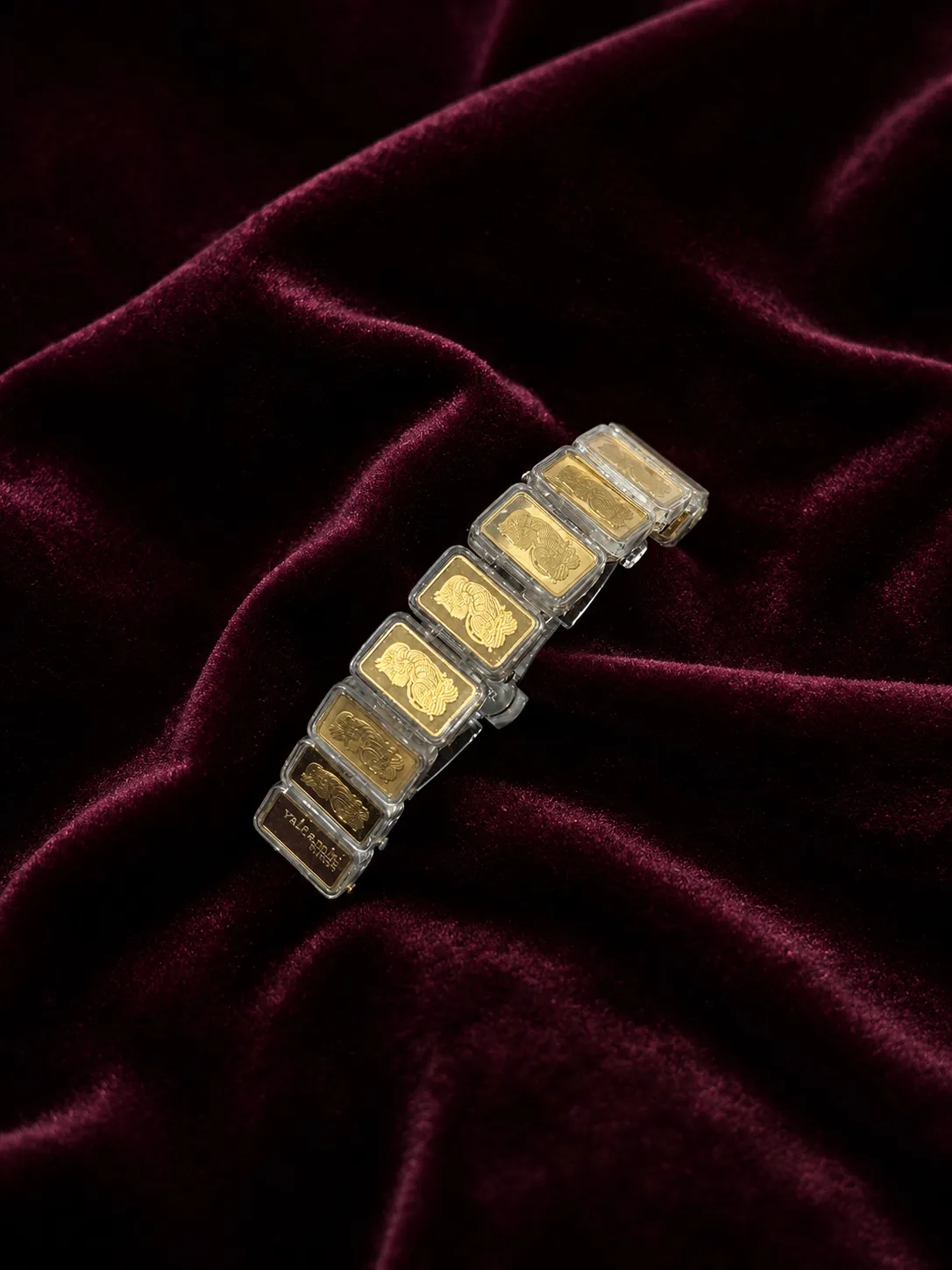 The bracelet laid on burgundy velvet