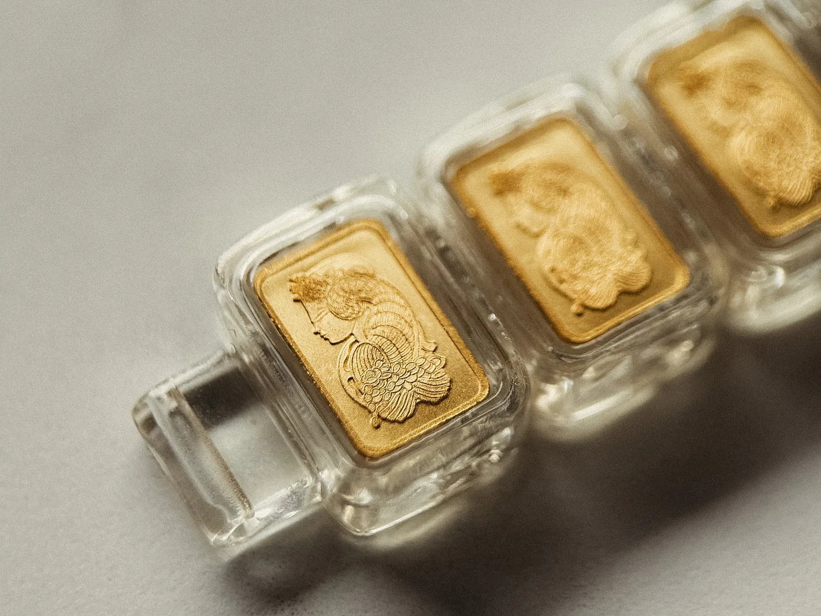 Gold bars fully visible inside the transparent capsules